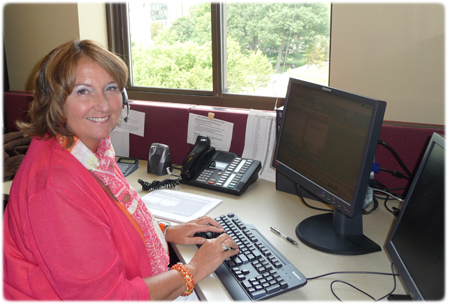 CCAP Senior Business Process Analyst Mary Hellenbrand working in the CCAP Call Center, which is now using an automated prompt to more directly route calls.