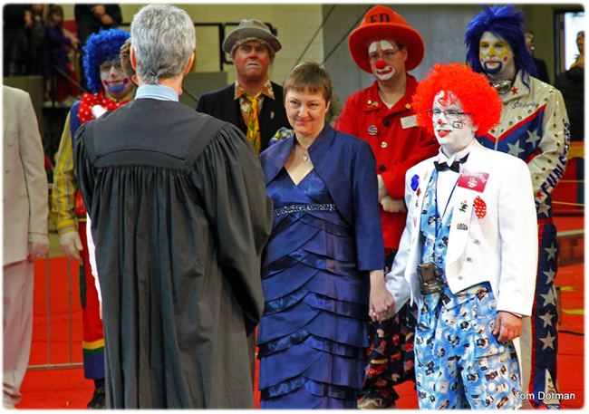 Peggy Spencer of the Supreme Court's Office of Management Services and Brad Andrew (a/k/a Shutterbox the Clown) were married on Feb. 16 during a ceremony in the center ring at the Zor Shrine Circus at the Veterans Memorial Coliseum, Madison. Bill Weigel of the Office of Lawyer Regulation, who is also a municipal judge, performed the ceremony. Photo credit: Tom Dorman, Management Services