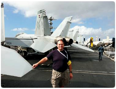 Chief Judge J. Mac Davis, Waukesha County Circuit Court, poses on the deck of the USS John C. Stennis while visiting his son, naval pilot Lt. Carl Davis during a family visit week.