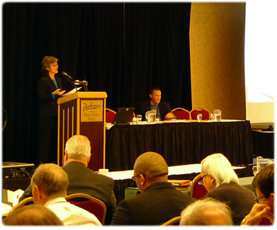 Judge William J. Domina, Waukesha County Circuit Court, right, chats by &ldquo;cell phone&rdquo; with Pam Radloff, deputy director, Management Services as part of a role-playing exercise during a session on public records at the Judicial Conference.
