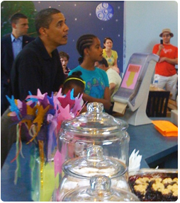 President Obama and his daughters place their order at the Dairy Godmother custard shop. Owner Liz Davis is the sister of Judge J. Mac Davis, Waukesha County Circuit Court. Photo credit: Daniel Schofield