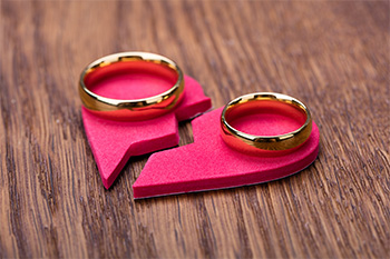 heart torn in two with wedding ring set on either half