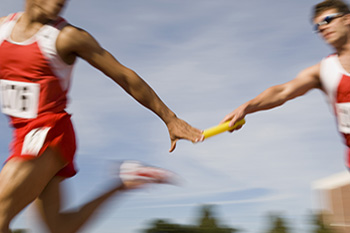 relay runners passing the baton