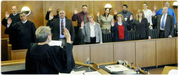 Second Judicial District Chief Judge Mary K. Wagner, Kenosha County Circuit Court, swears in the Veterans Treatment Court team, which includes Racine County Circuit Court Judges Gerald P. Ptacek and Michael J. Piontek (far left).
