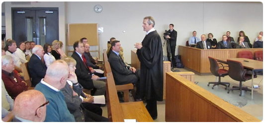 Chief Judge Benjamin D. Proctor (now retired) explains the goals of the Chippewa Valley Veterans Treatment Court at a January 2011 ceremony to open the new court program.